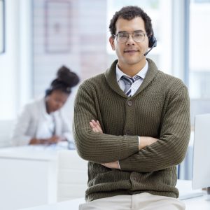 Sales is my game. Portrait of a young businessman wearing a headset while working in an office